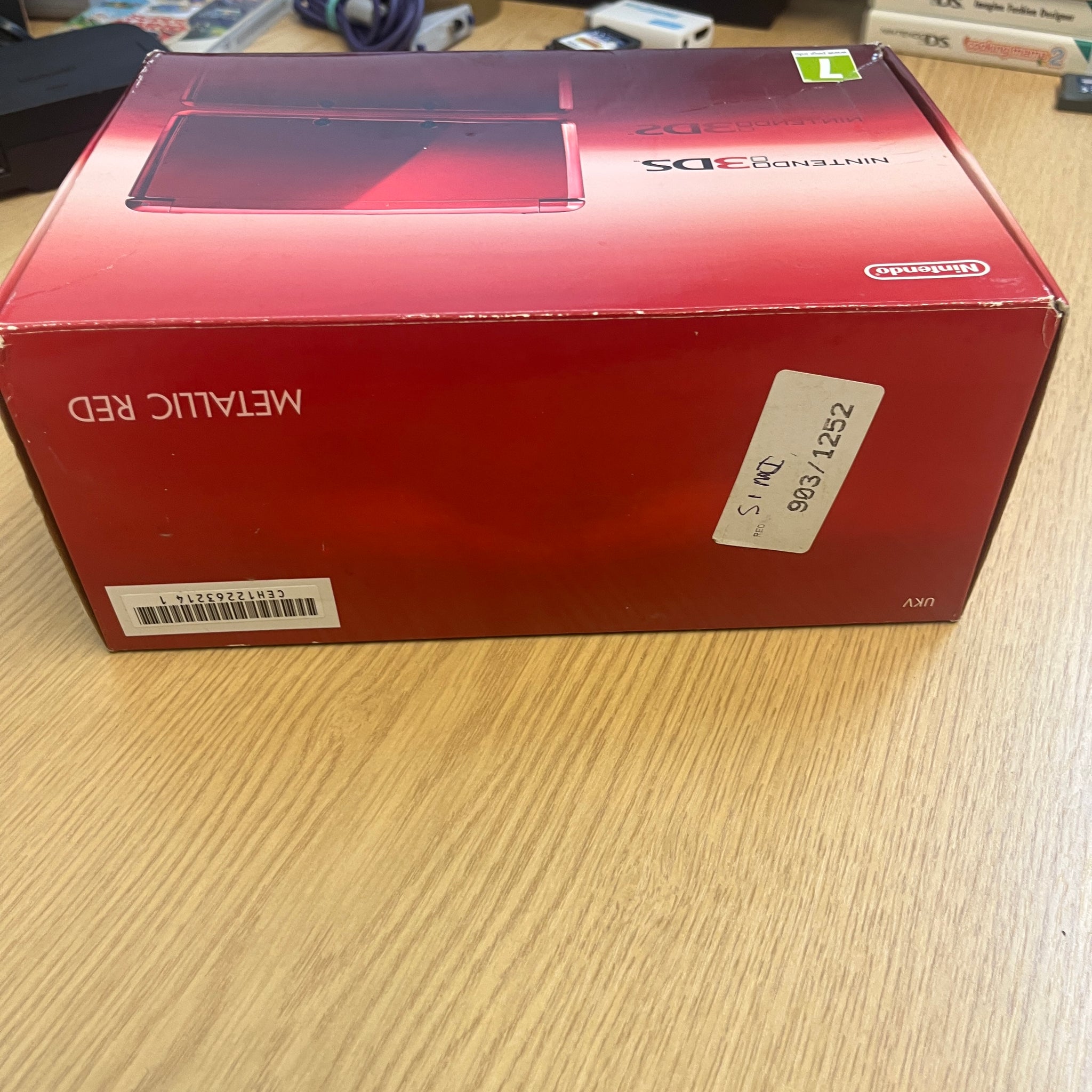 Boxed metallic red Nintendo 3ds console – retro game store