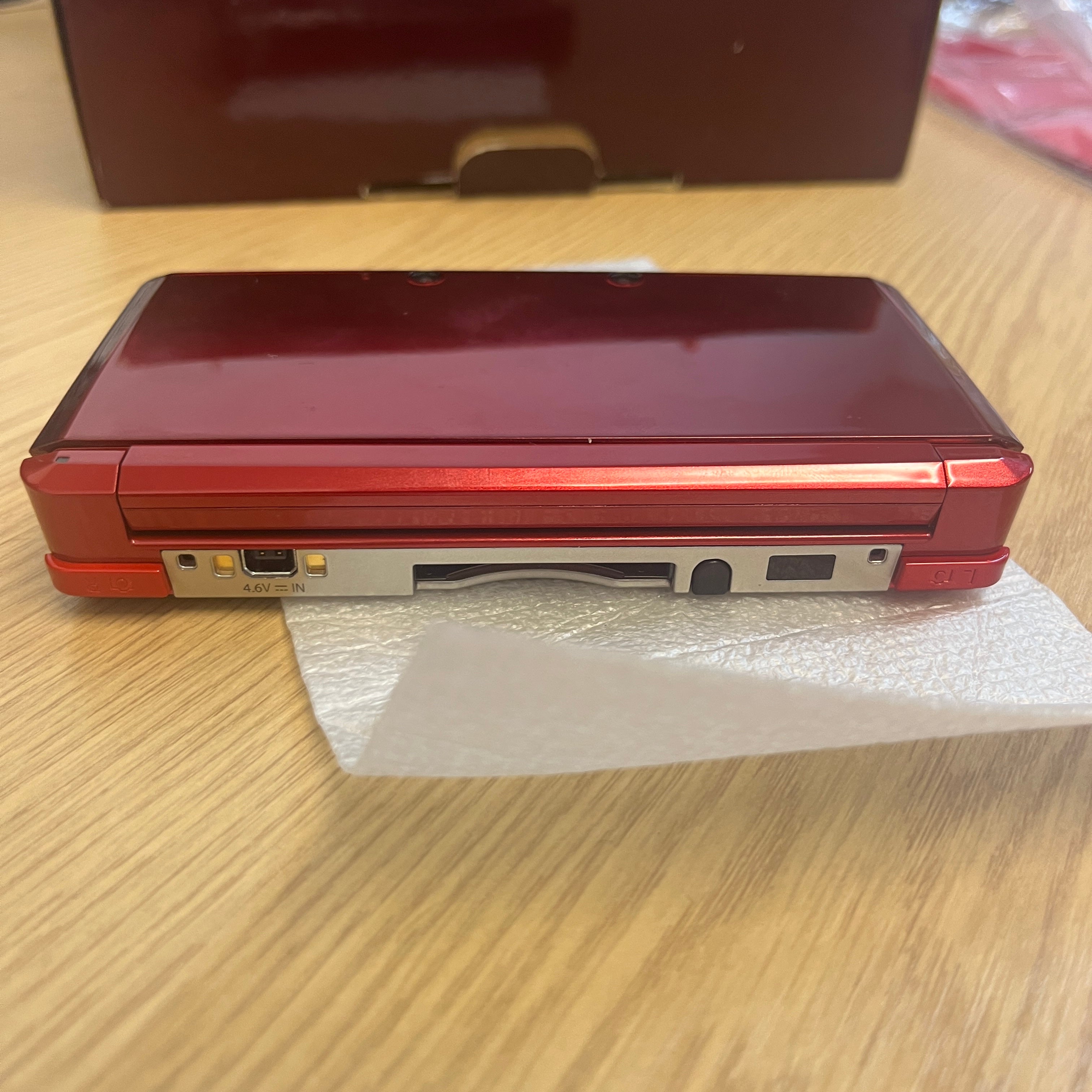 Boxed metallic red Nintendo 3ds console