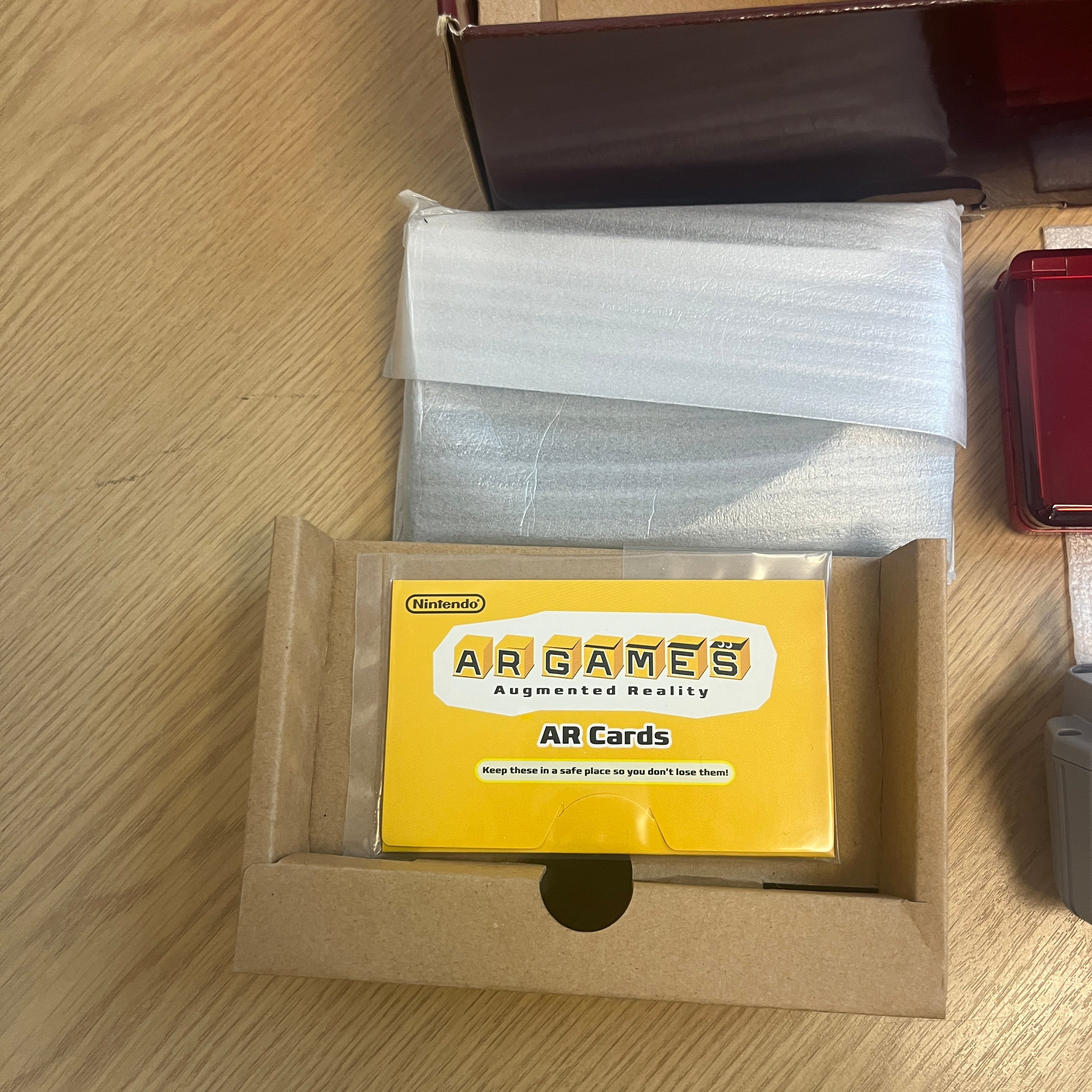 Boxed metallic red Nintendo 3ds console